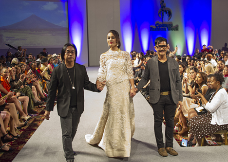 Designer Barge Ramos (left) and jewelry designer Arnel Papa (right) take a bow at Couture Fashion Week New York