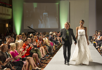 Fashion designer Joseph Domingo takes a bow at Couture Fashion Week New York